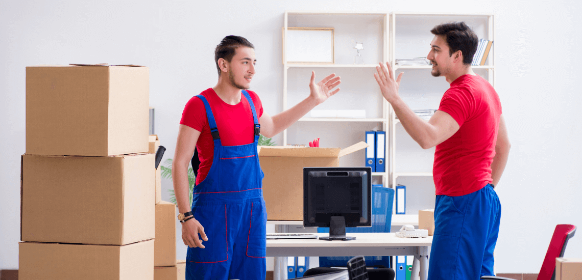 Professional movers working with packed household goods